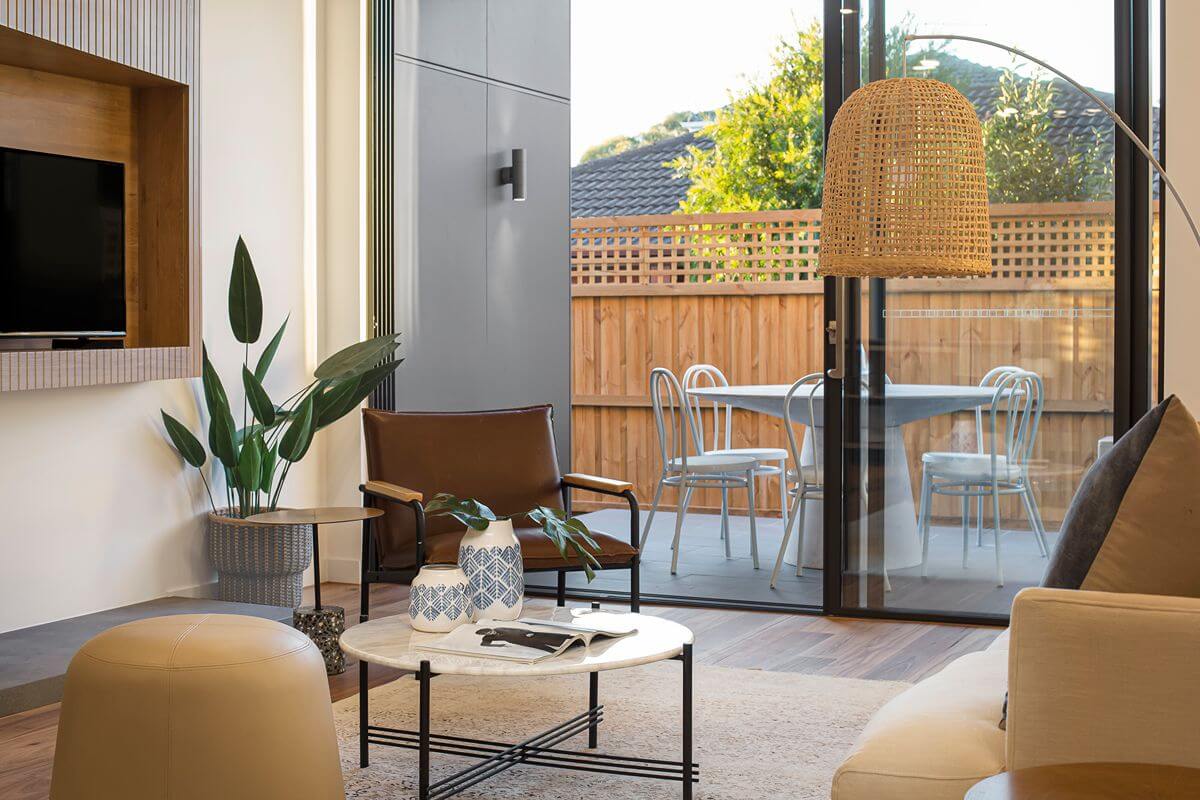 Modern condominium living room with stylish furnishings, natural light, and seamless access to a private outdoor patio.