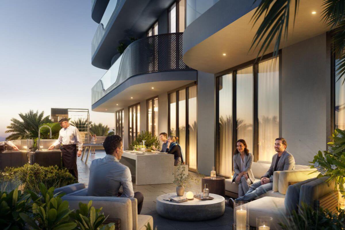 Residents relaxing on a landscaped condominium terrace with outdoor seating and dining areas
