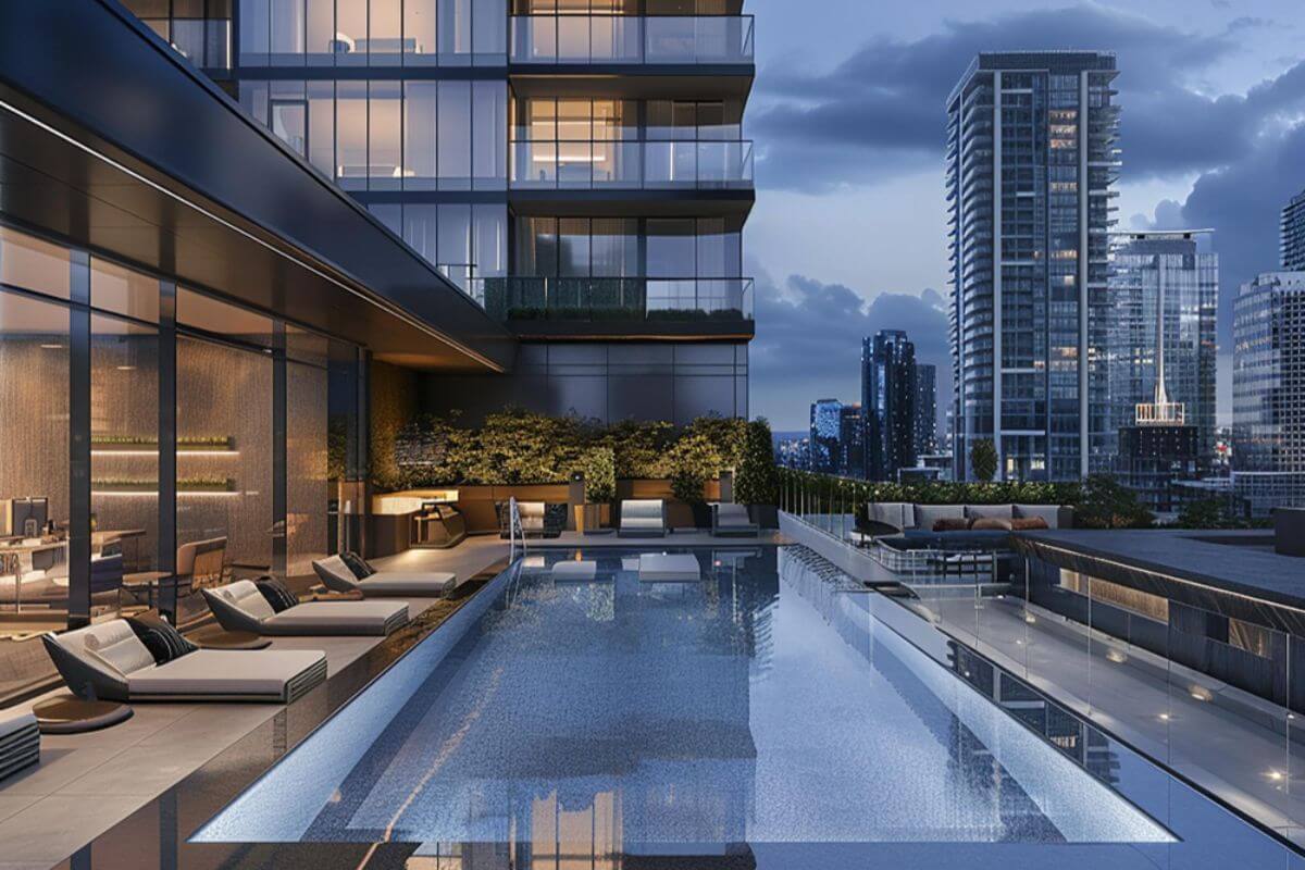 Luxury condominium pool deck with lounge seating and skyline views at dusk