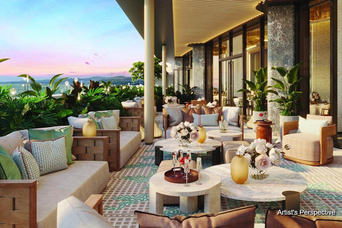 Artist’s rendering of a landscaped outdoor terrace with cushioned seating, round tables, tropical plants, and a panoramic sunset view