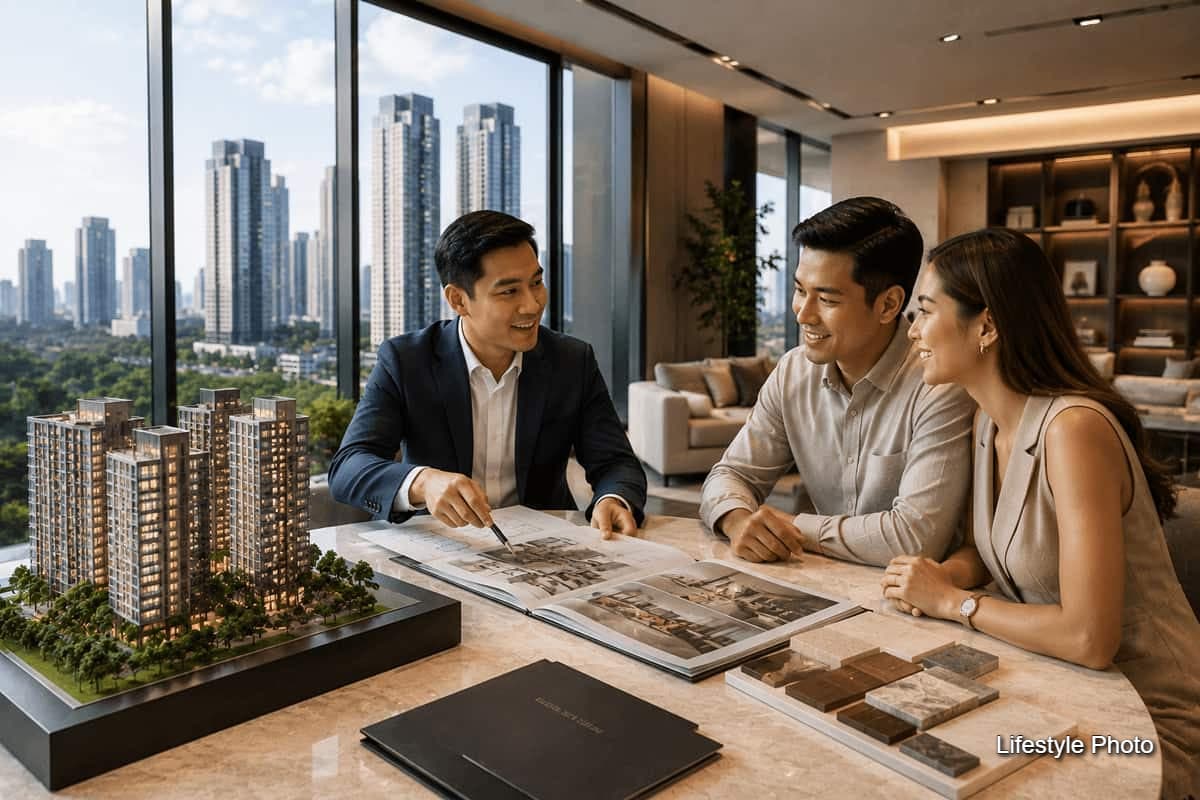 Real estate adviser discussing a condominium scale model and property plans with a couple in a high-rise sales suite