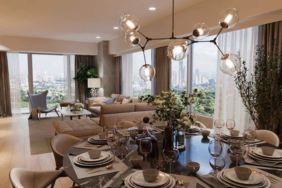 Elegant condominium living and dining area with floor-to-ceiling windows overlooking a developing cityscape