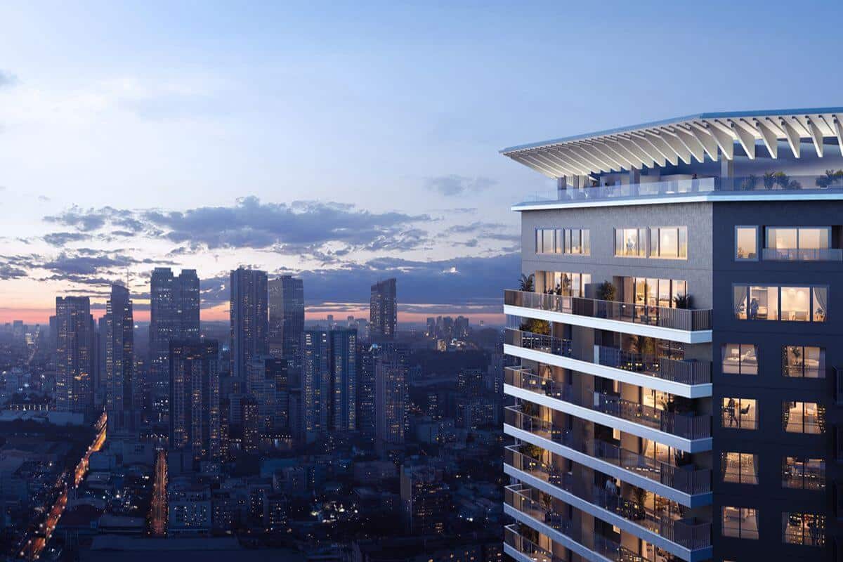 Modern luxury residential tower overlooking the city skyline at dusk, highlighting premium mixed-use urban living