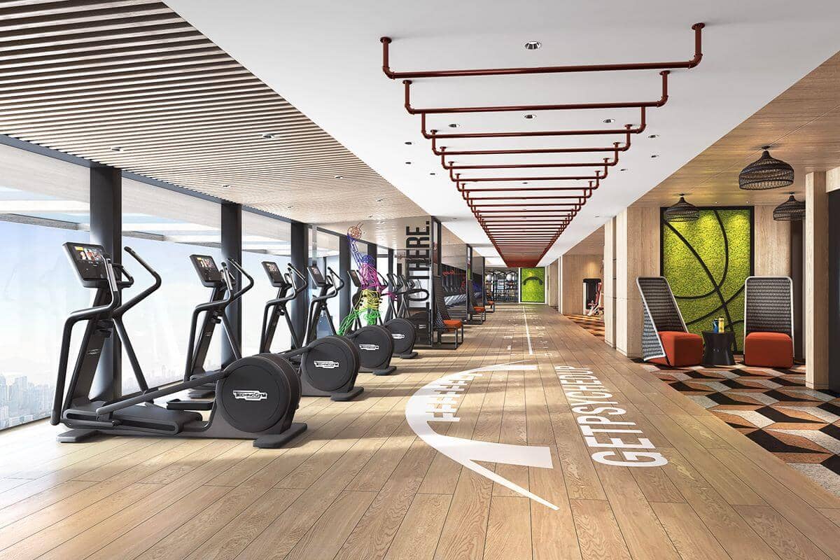 Modern luxury condominium fitness center with cardio equipment, exercise zones, and contemporary wellness facilities