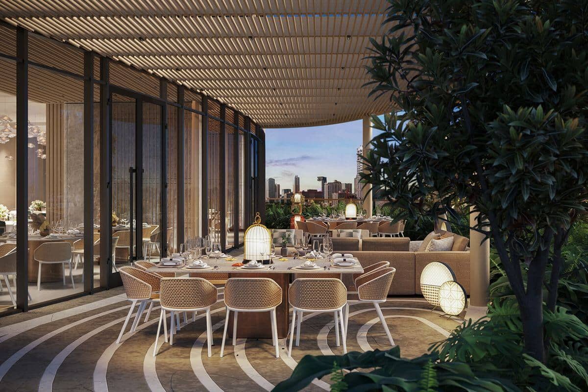 Elegant outdoor private lounge and dining area surrounded by greenery, designed for gatherings and relaxed luxury living