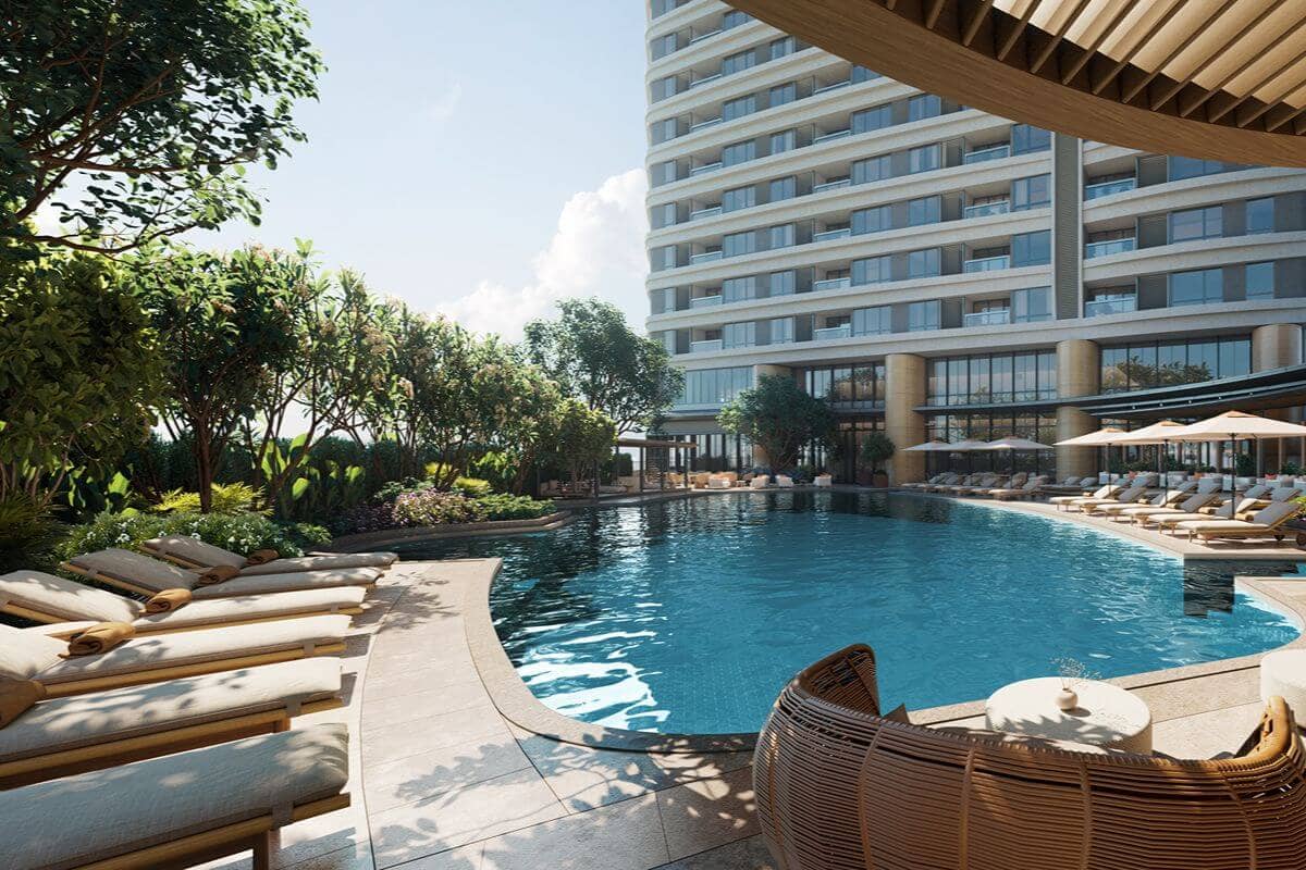 Resort-style swimming pool with lounge seating and landscaped greenery within a luxury residential development