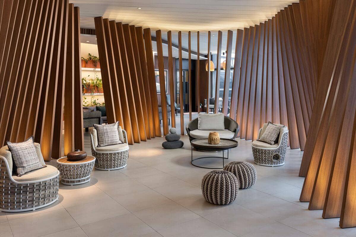 Elegant condominium lounge with contemporary seating and wood accents, representing a professionally managed residential environment