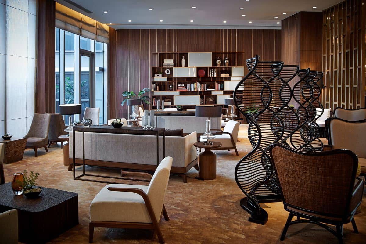 Well-maintained luxury residential lounge with refined furnishings, warm wood accents, and comfortable communal seating