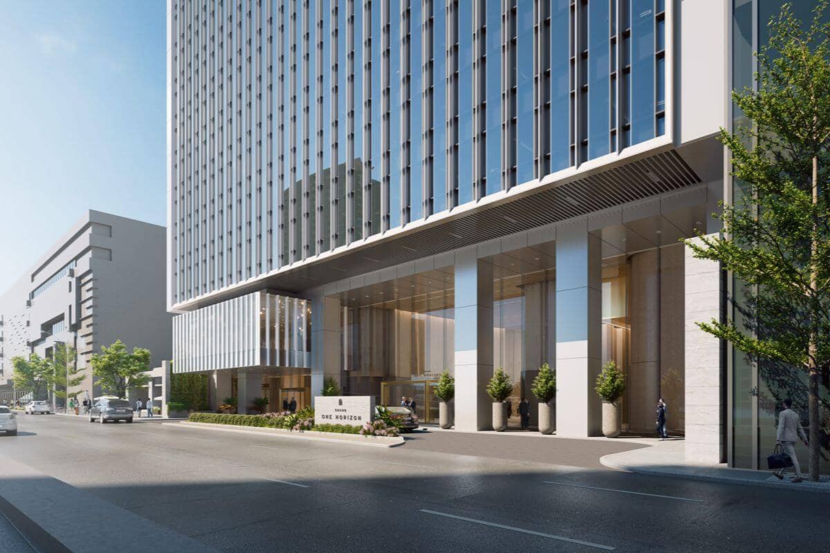 Modern luxury residential building entrance along an urban street, reflecting refined property management and premium city living