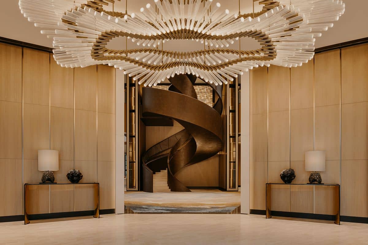 Sophisticated Shang Properties interior with sculptural lighting, refined finishes, and an artistic centerpiece reflecting premium property standard