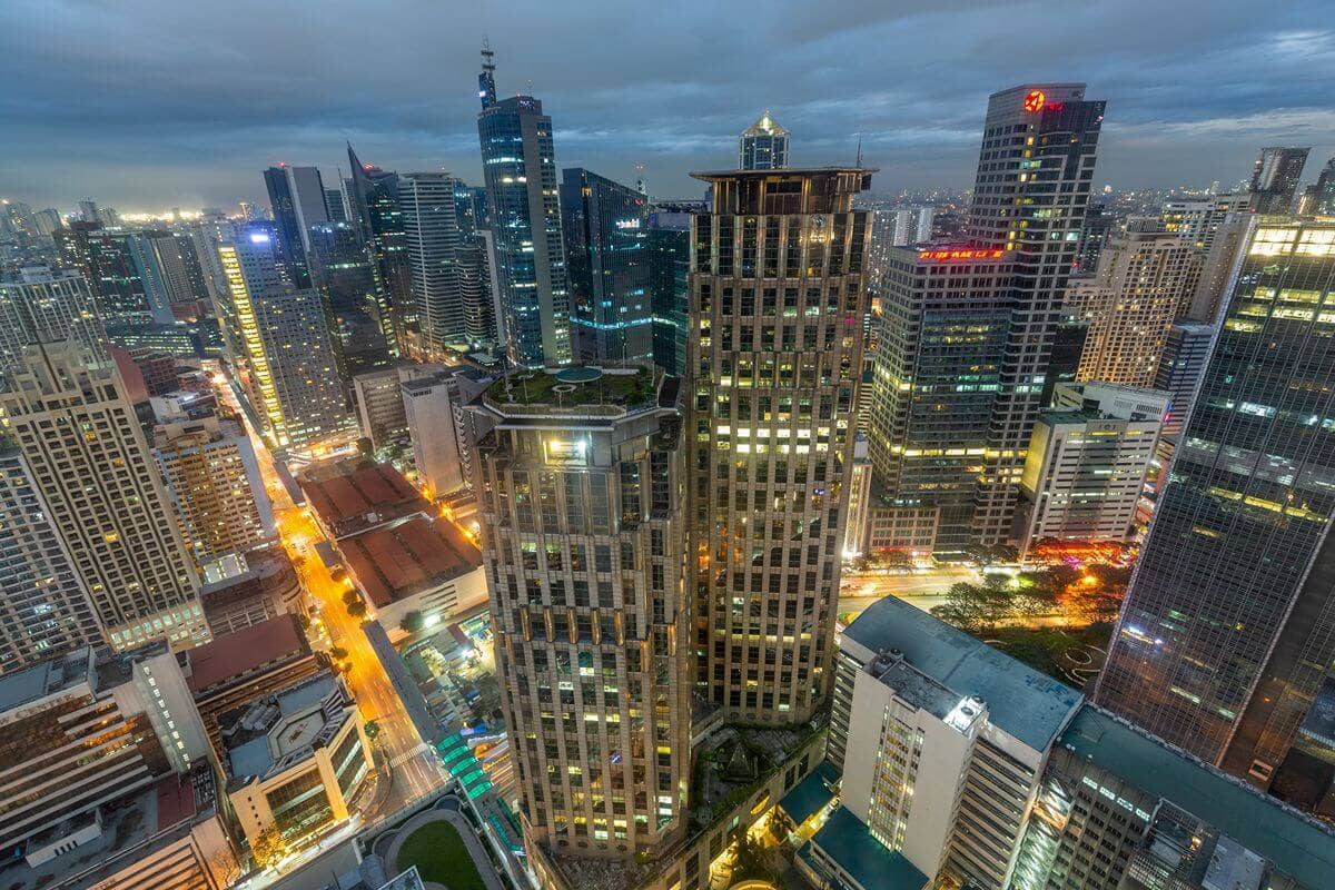 Luxury condominium towers within a dense city skyline at dusk, representing premium urban living and long-term property value