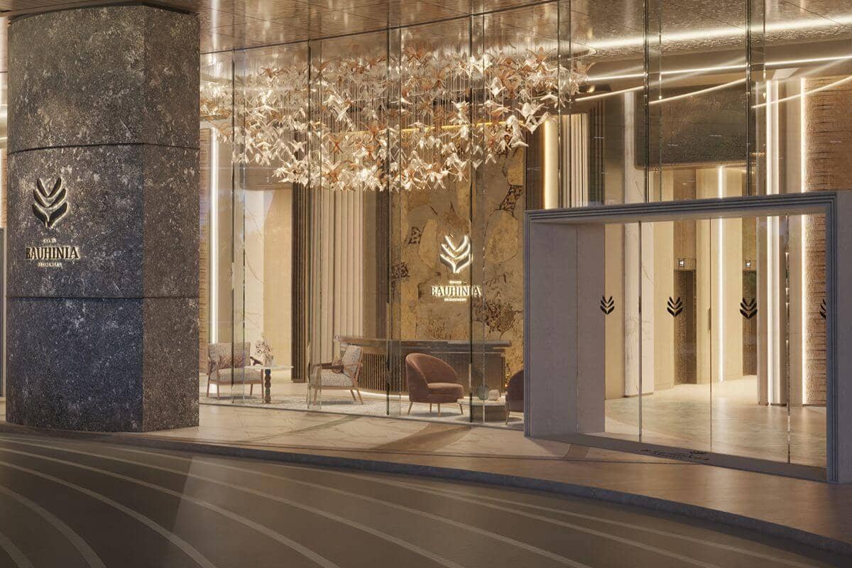 Elegant high-end condominium entrance with illuminated architectural details, reflecting premium design and strong market positioning