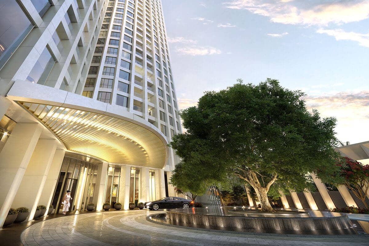 Luxury residential tower entrance with landscaped surroundings, showcasing a prime urban location and upscale condominium living