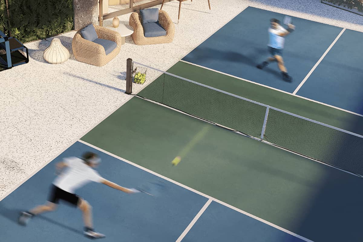 Residents playing tennis at a landscaped Shang Properties recreational court, showcasing active amenities within a unified residential community